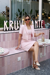 a lady wears a pink crop jacket with a matching vest dress